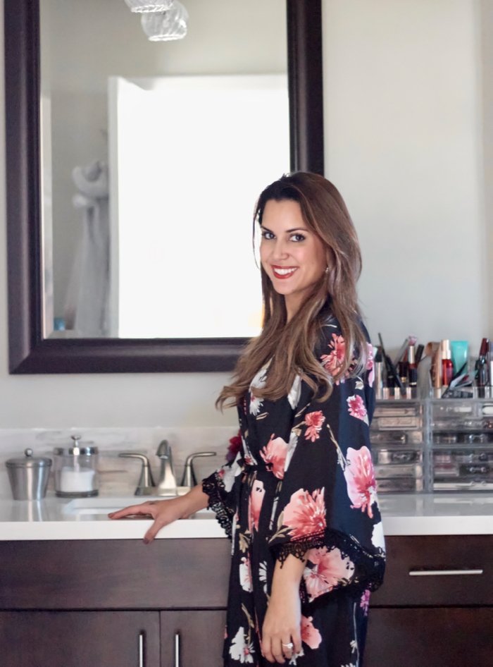 woman standing in bathrobe in bathroom