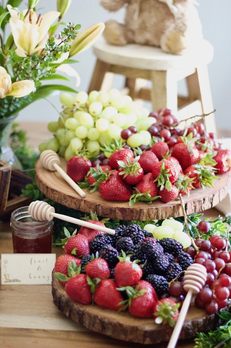 Fruit and honey display baby shower idea. Click to see even more food ideas from this Classic Winnie the Pooh baby shower! 