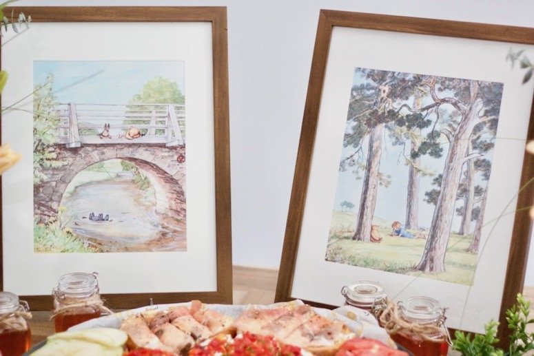 Classic Winnie the Pooh framed art for a Winnie the Pooh themed baby shower! Click to see even more of the decor and food ideas in the post 