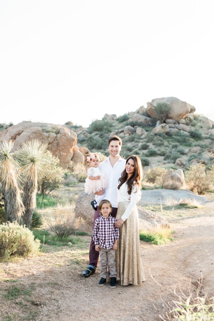 What to wear for family pictures outside | family of 4 standing in Arizona desert for family photos, woman in gold sequin skirt | lifewithmar.com