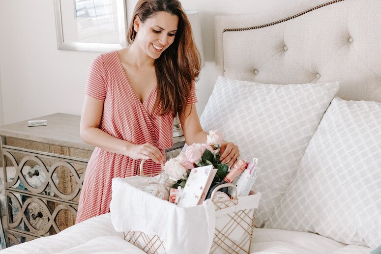 woman creating luxury Mother's Day gift basket 