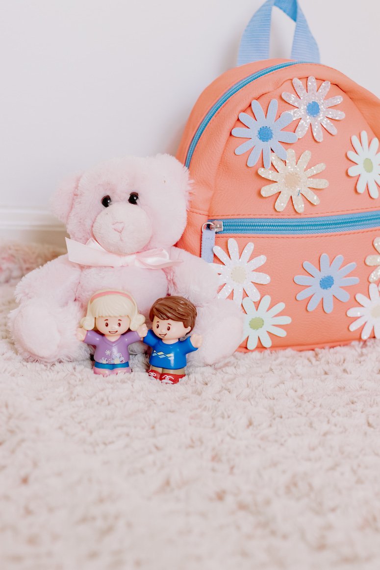 pink toddler backpack and toys