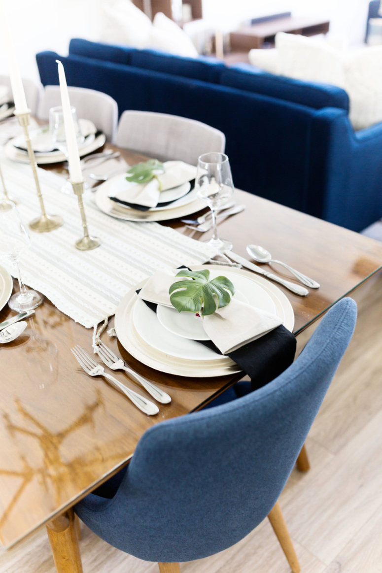 easy elegant neutral dinner party tablescape idea featuring fiddle leaf fig napkins rings