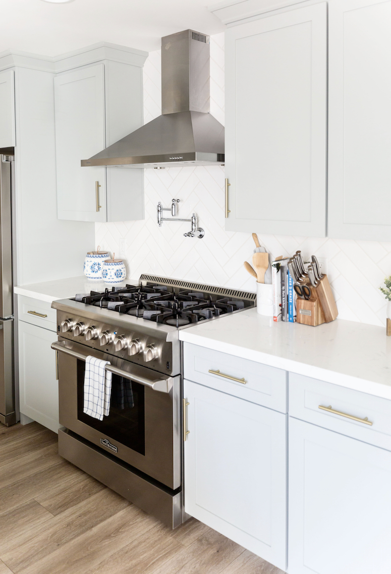 bluish grey kitchen cabinets with gold hardware 