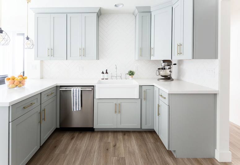 grey kitchen cabinets with gold hardware white subway tile herringbone