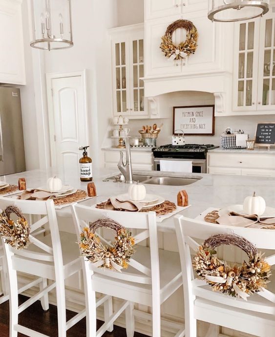 fall kitchen wreath above stove and on chairs