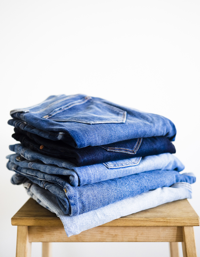 set fashion goals-declutter and donate. Stack of denim jeans
