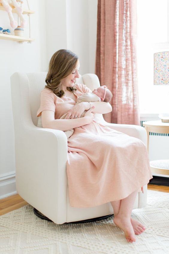 mom dressed in an a-line dress in baby nursery