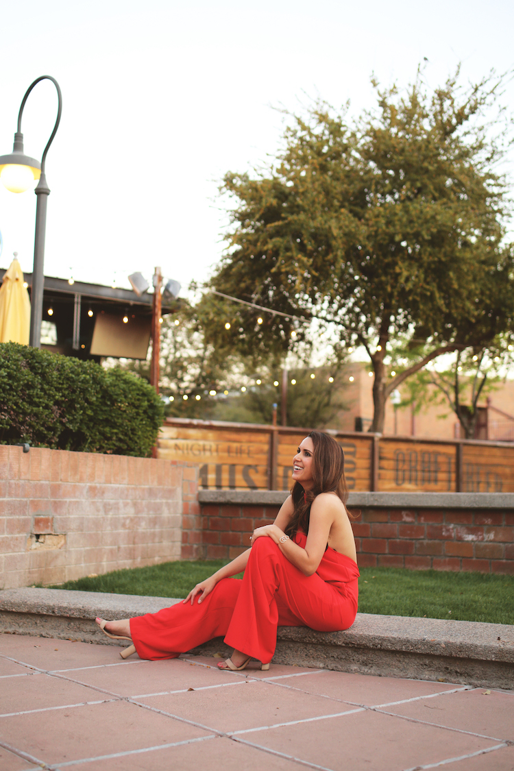 red jumpsuit with beige heels