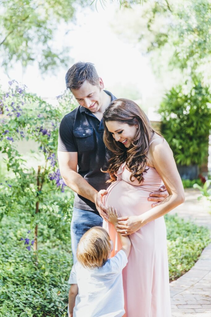 maternity photos second baby mom with pink maternity dress husband and toddler