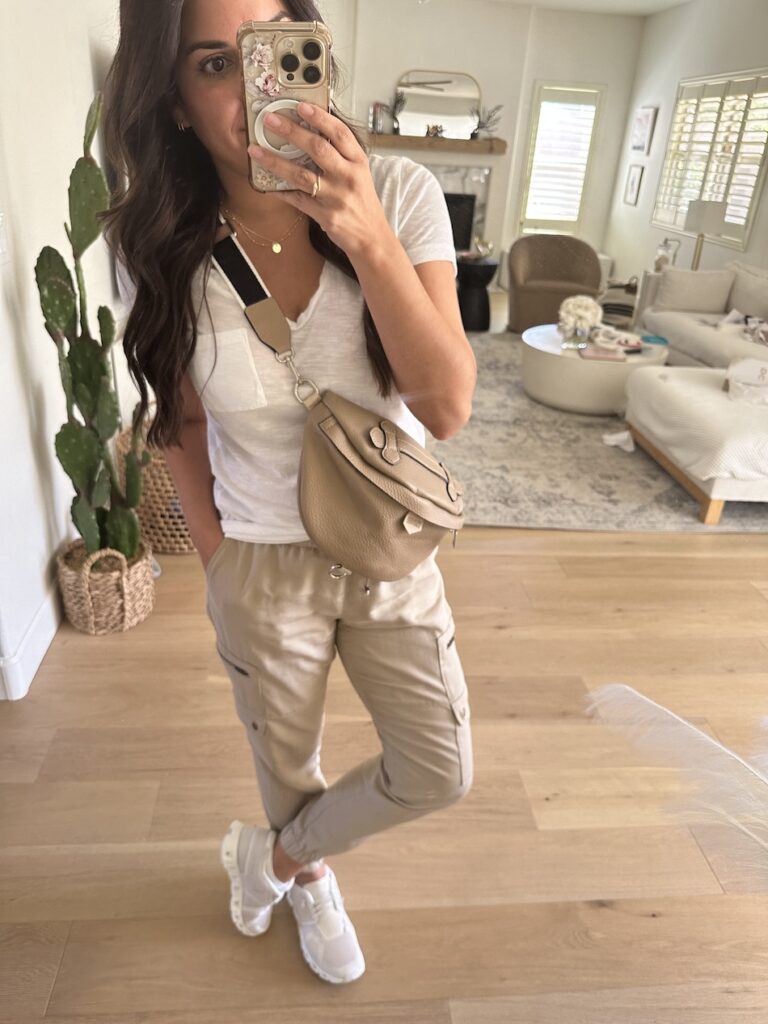 beige cargo pants with t-shirt and sneakers and bumbag